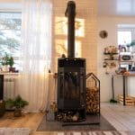 Black stove, fireplace in interior of house in loft style. Alter