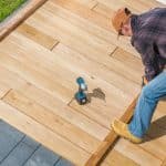 Men Building Wooden Deck on His Backyard
